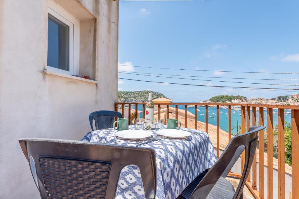 a table on a balcony with a view of the ocean at The Olives in Port de Soller