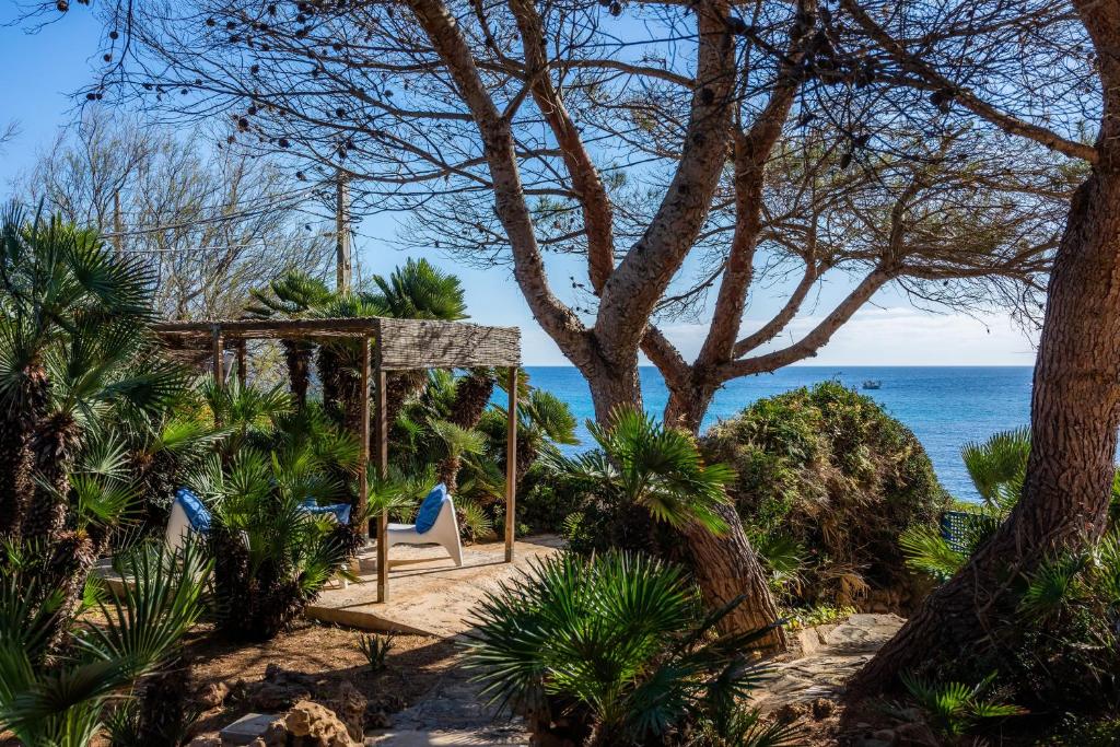 a swing on the beach with the ocean in the background at Finca Es Carregador in Capdepera