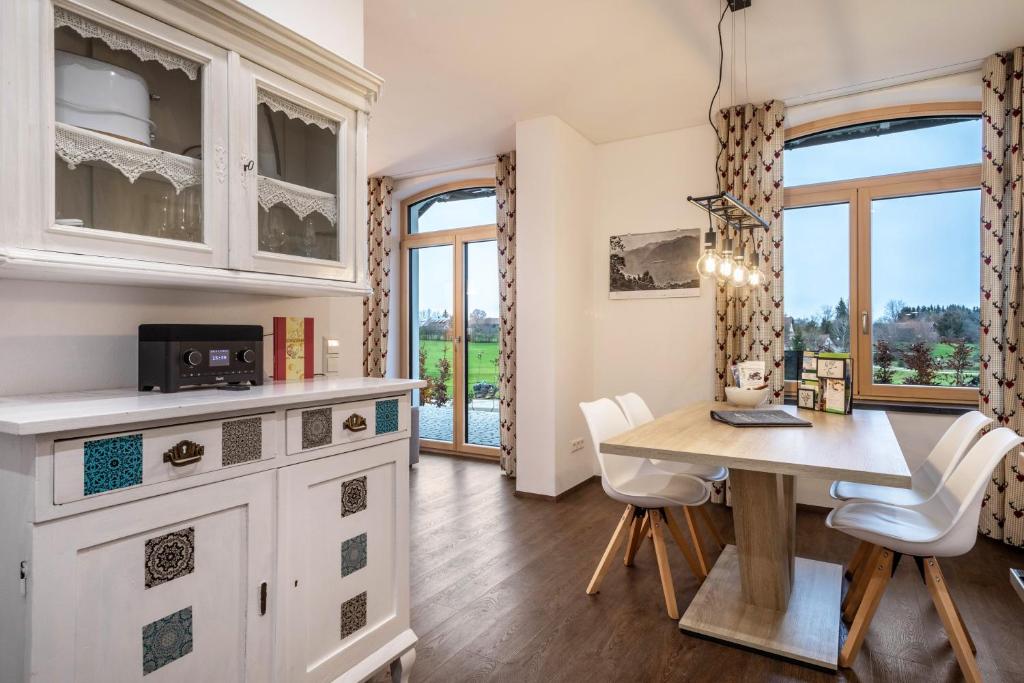 a kitchen with a table and chairs and a window at Butterei in Argenbühl