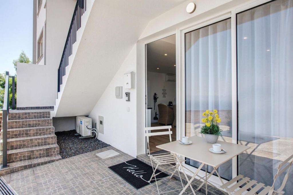 a room with a table and chairs and stairs at Studio Casa Belavista in Gaula