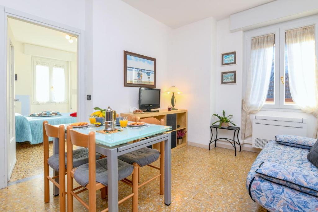 a kitchen and living room with a table and chairs at Liver 201 in Tremosine Sul Garda