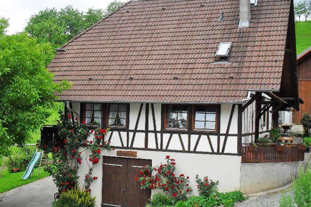 a black and white house with a brown roof at Schlossberghof Schnellingen in Haslach im Kinzigtal