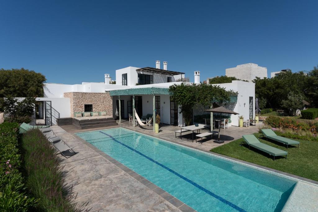a swimming pool in front of a house at Villa Celeste-Essaouira, piscine chauffée, vue sur la campagne in Essaouira