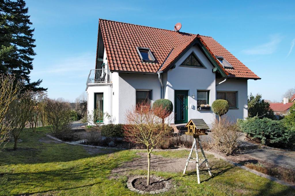 a small white house with a red roof at Süd-Balkon an der schönen Peene in Demmin