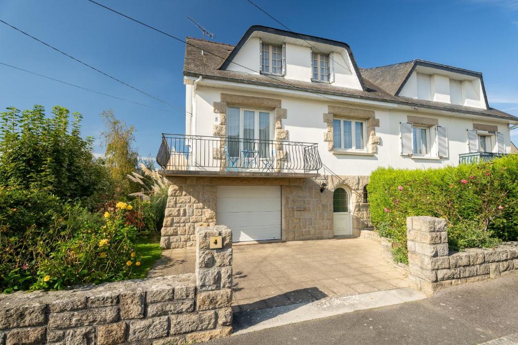 a large white house with a garage at Maison De Caractère in Cancale