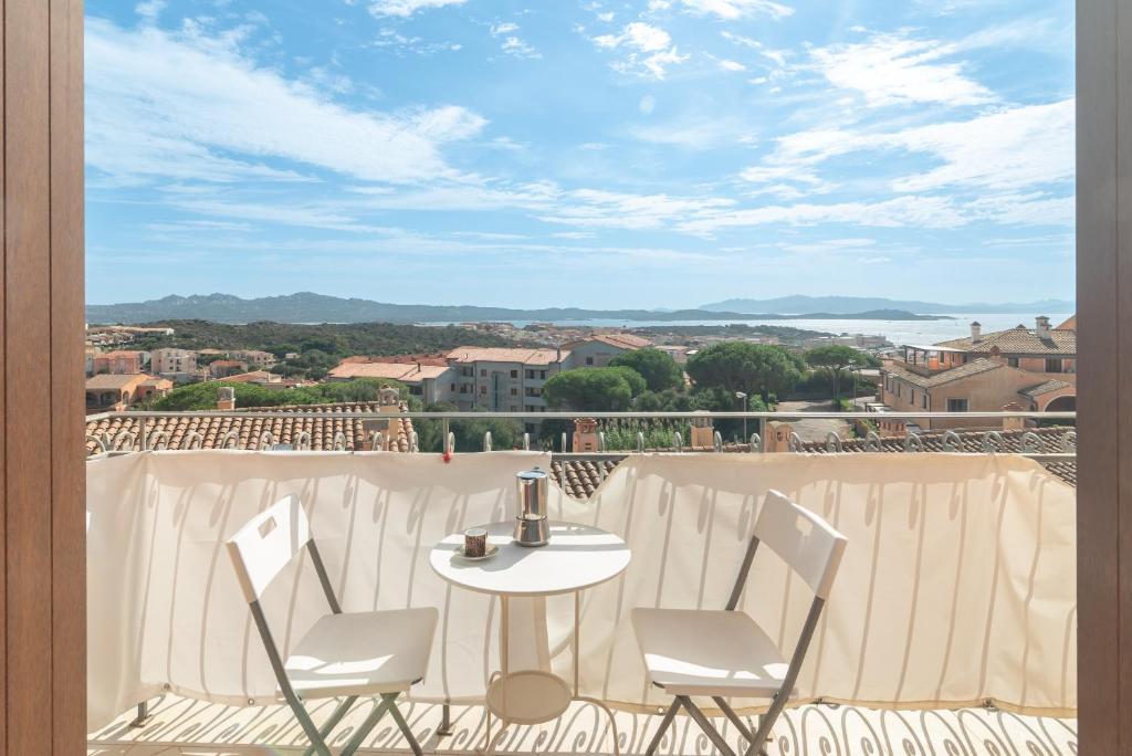 a table and chairs on a balcony with a view at B 104 Puntavilla Mare in La Maddalena
