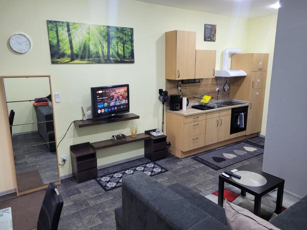 a room with a living room with a tv in it at Wohnung in Elz in Elz