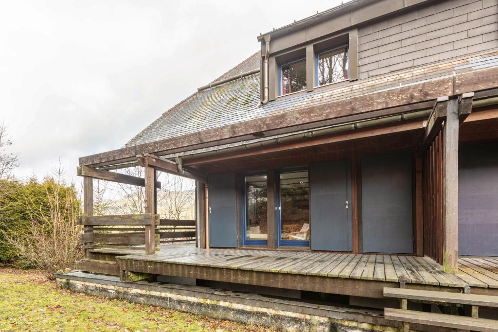 a house with a wooden porch on the side of it at Ferienwohnung Herzogenhorn in Bernau im Schwarzwald