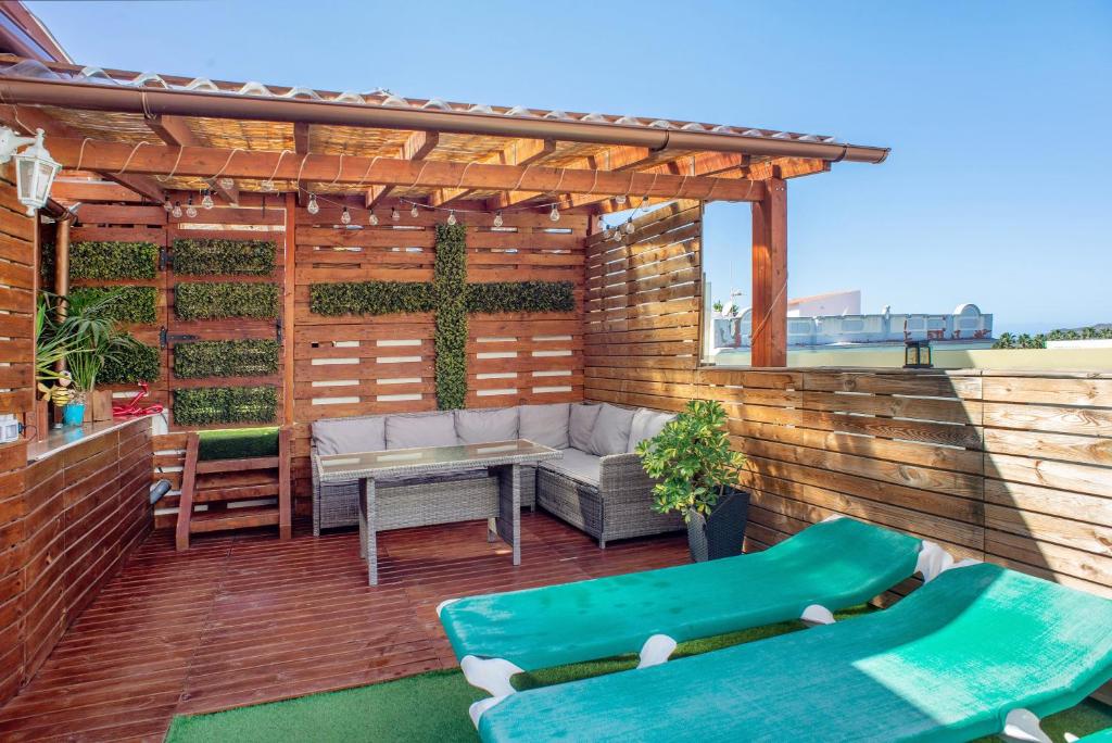 a patio with a couch and a table and chairs at Casa La Palmilla in San Nicolás