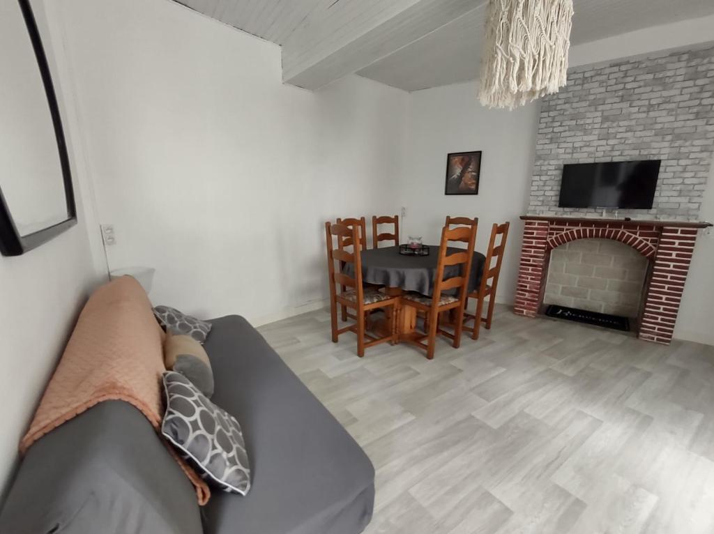 a living room with a couch and a fireplace at Séjour familial au Gite Iza – Lorme in Lormes
