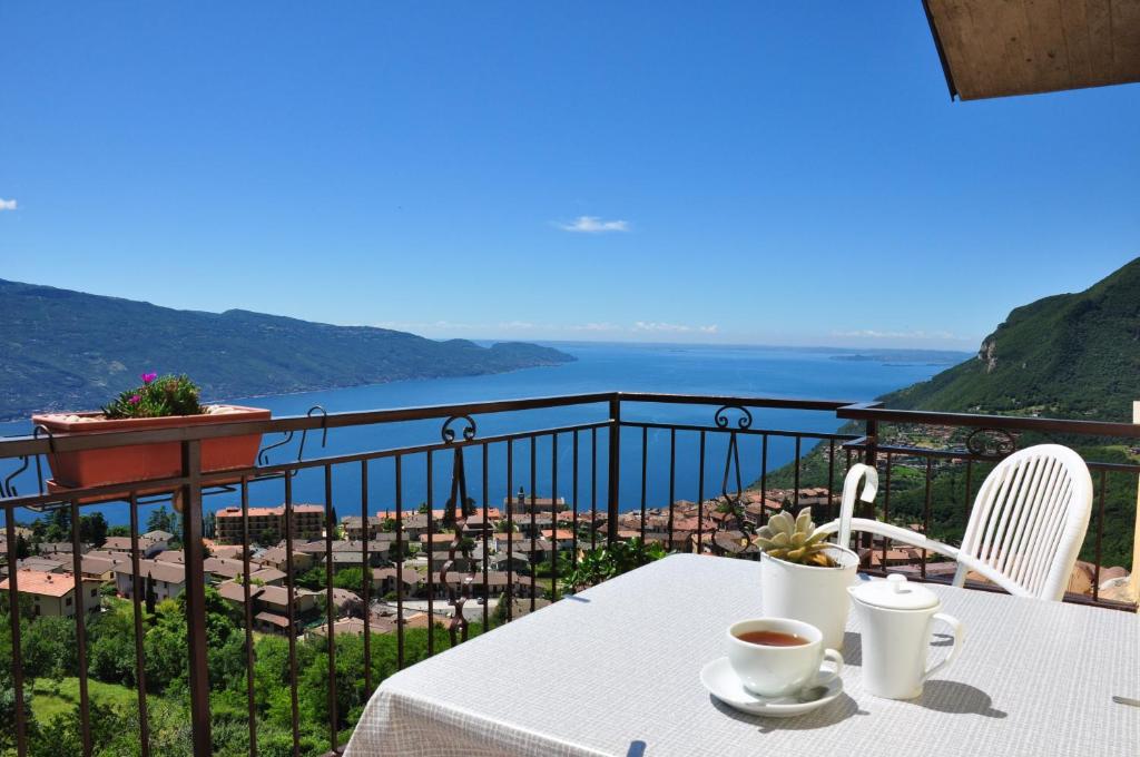 a table with two cups of coffee on a balcony at Stella del Garda 1 con balcone in Tignale