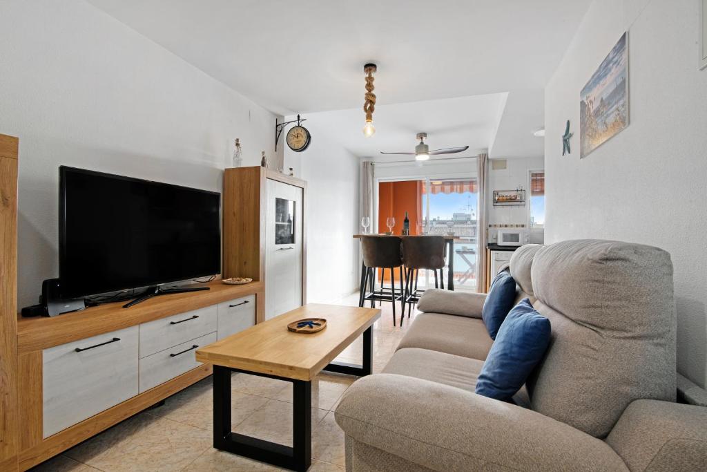 a living room with a couch and a flat screen tv at Casa Pera in Xilxes