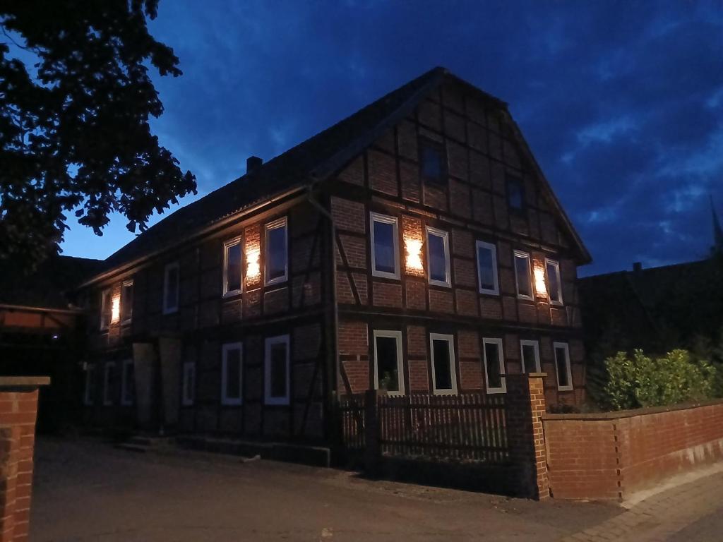 a house with lights in the windows at night at Ferienwohnung 1 Bartölke in Bockenem