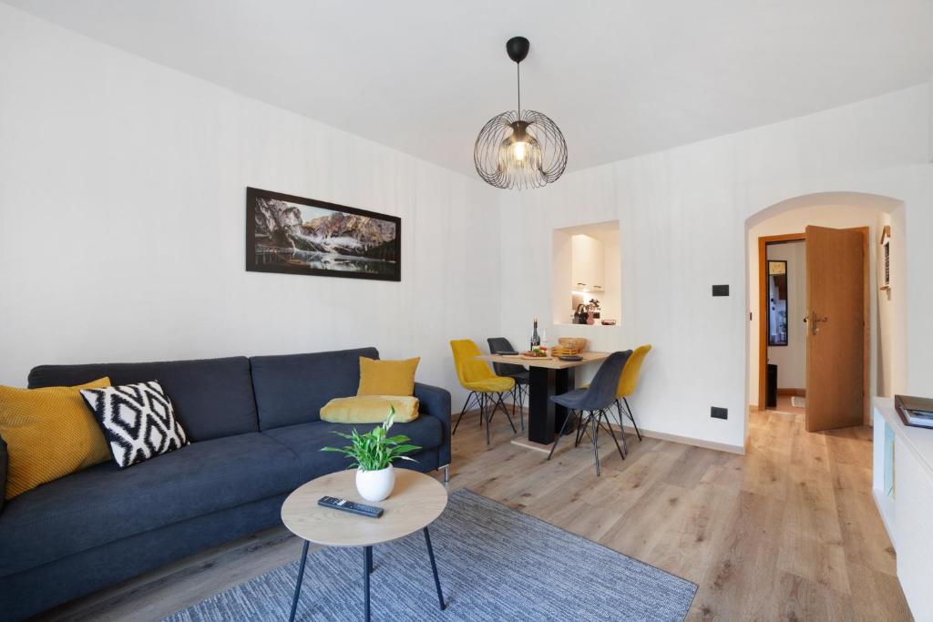 a living room with a blue couch and a table at Appartment Riffl Anna in Rifiano