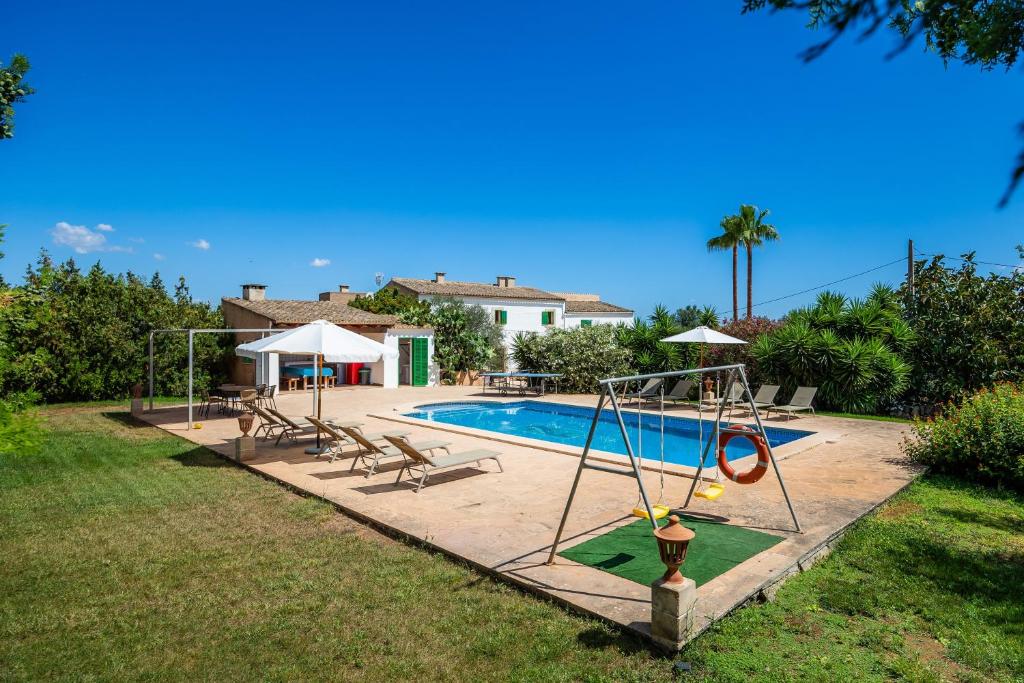 a swimming pool with a swing and a playground at Na Amera Ref 225 in Campos