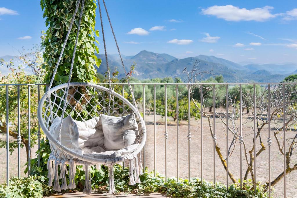 a white chair hanging from a fence at Villa Is Sorrisi in Gonnesa