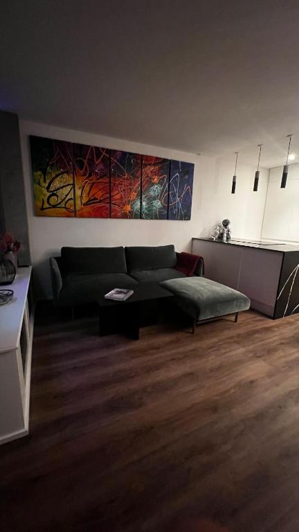 a living room with a couch and a table at Design Apartment in Vesterbro with Large Balcony in Copenhagen