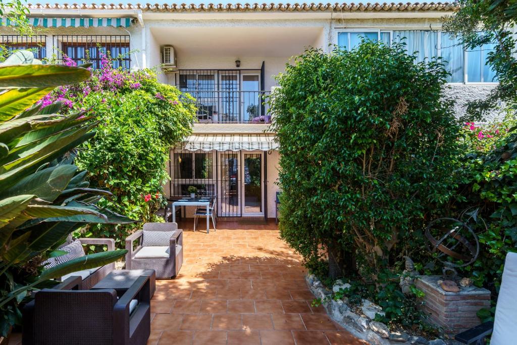 a courtyard of a house with plants and a patio at La Ponderosa 5 in Mijas Costa