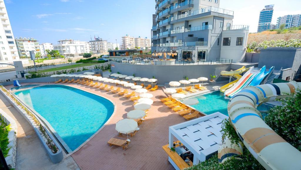 an overhead view of a pool with chairs and umbrellas at Athena Premium Suites in Erdemli