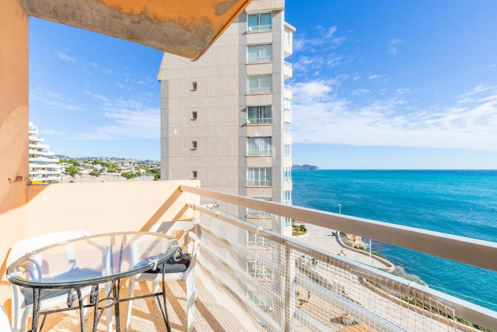 a balcony with a view of the ocean at Calpe primera linea con piscina in Casas de Torrat