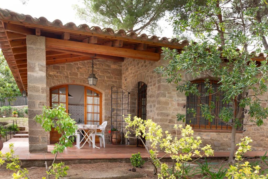 a patio of a house with a wooden deck at Ca la Irene I in Begur
