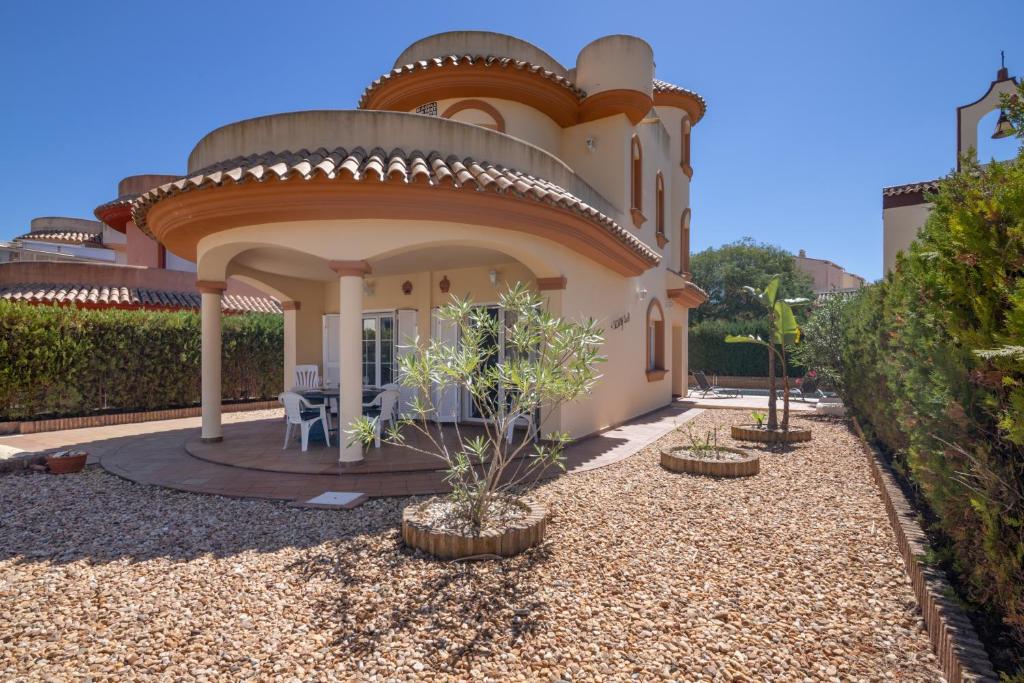 a house with a circularvisor on the front of it at Luxury villa in Islantilla