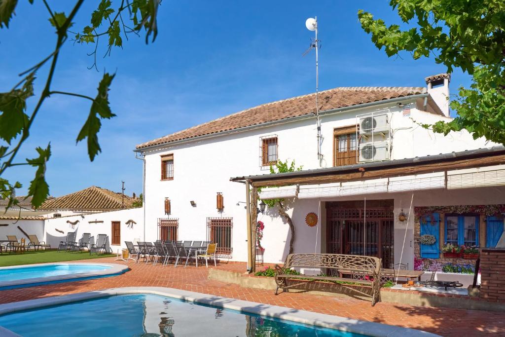 a house with a swimming pool in front of it at Cortijo Las Gregorias in Lucena