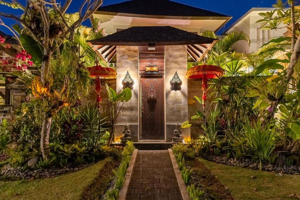 a front door of a house with plants at Villa Sulastri - Tanah Lot in Tanah Lot