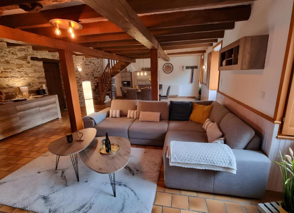 a living room with a couch and two tables at La Maison Neuve in Béganne