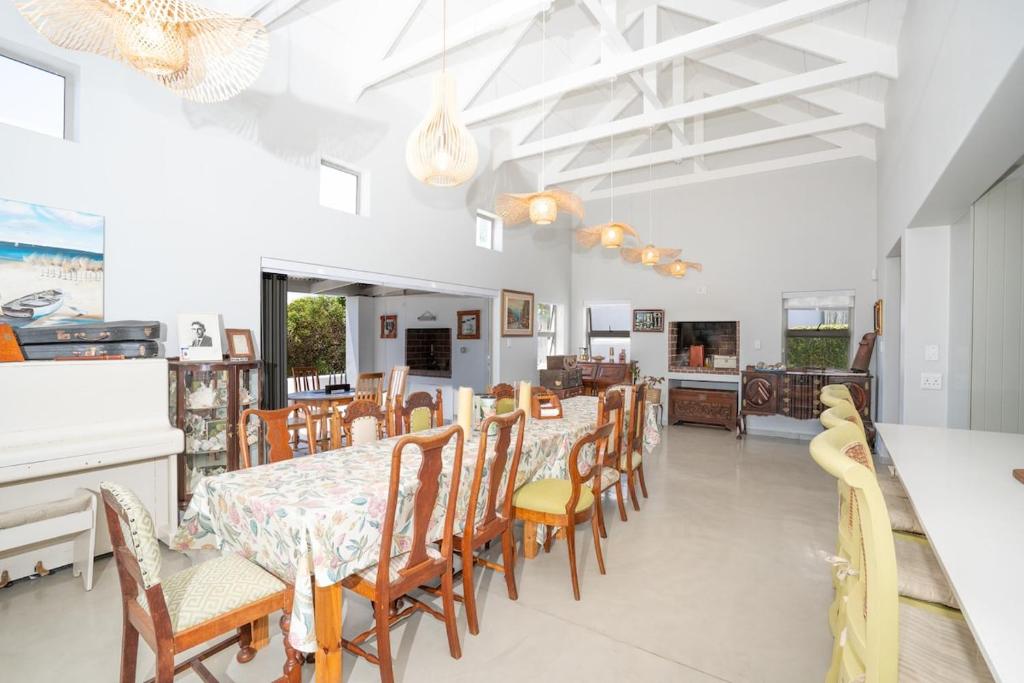 a dining room with a table and chairs at Our Father in Paternoster