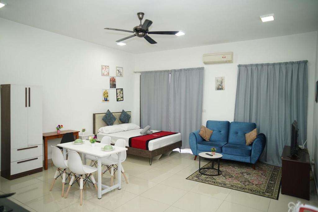 a living room with a couch and a table at Cozy Studio Netflix Parking Self Checkin Wifi free wifi 138 in Cyberjaya