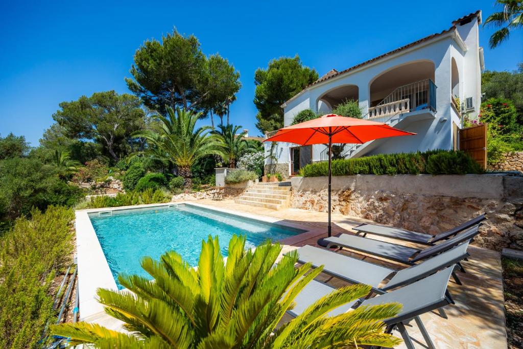 a villa with a swimming pool and a house at Casa Inés in Cala Murada