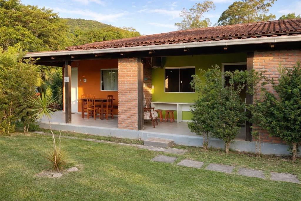 a house with a patio and a yard at Refúgio do Bosque in Penha