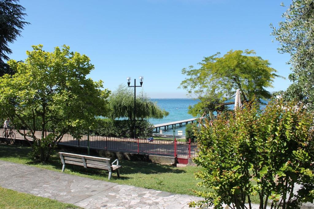 a park bench with a view of the ocean at Favola Bella in Bardolino