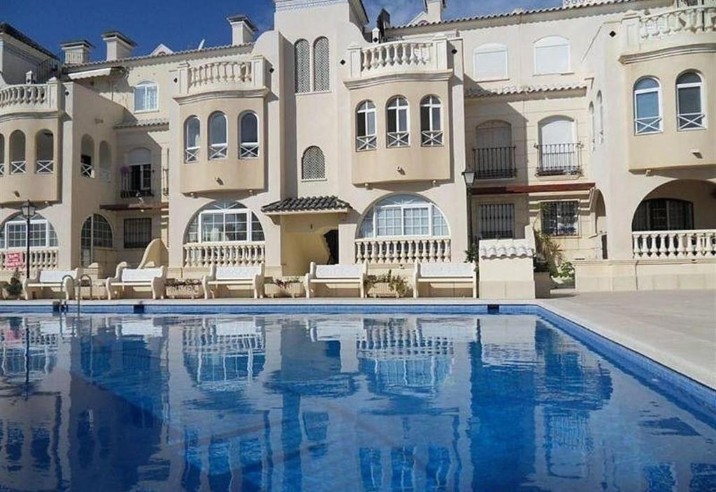a large building with a swimming pool in front of it at Duquesa Beach in Torrevieja