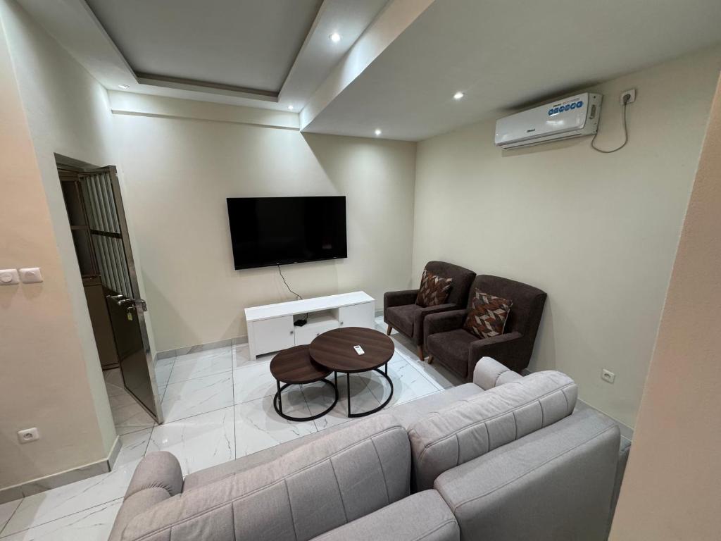 a living room with a couch and a table at IMMEUBLE COSMOS Kintambo in Kinshasa