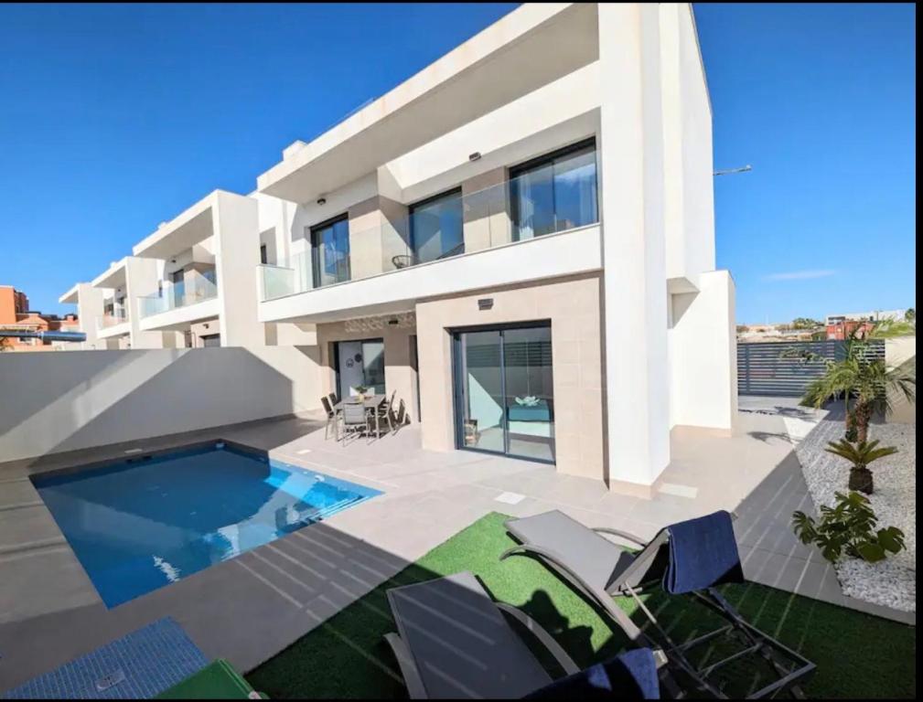 a large white house with a swimming pool at R-53 Corner Villa with private pool in Los Montesinos