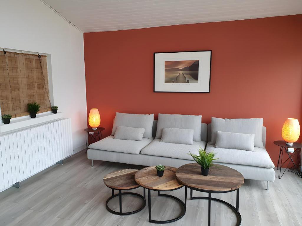 a living room with a couch and two tables at Ô'wazo, Jolie Maison, Piscine in Lanton