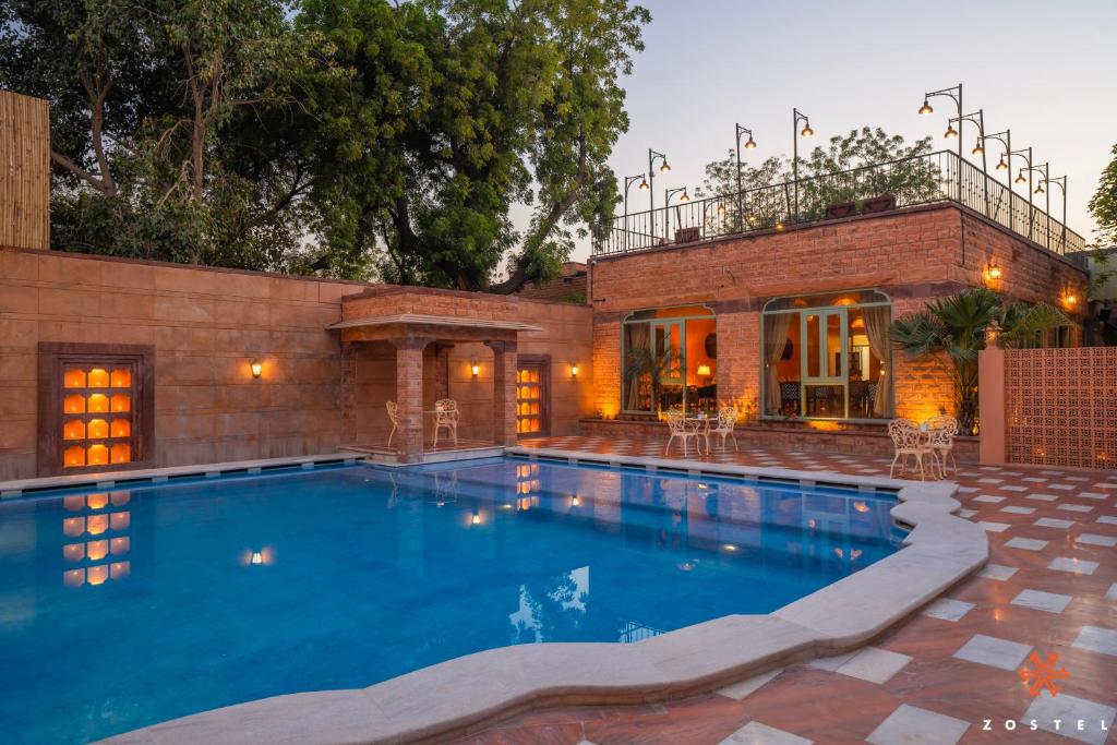 a swimming pool in front of a house at Zostel Jodhpur, Ratanada in Jodhpur