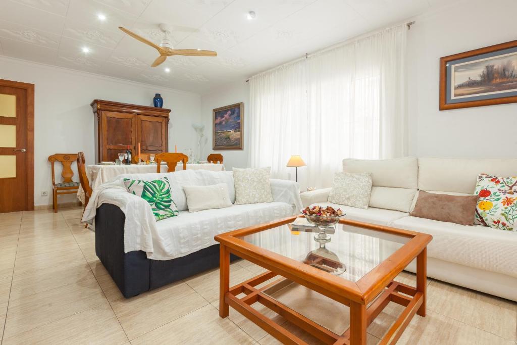 a living room with a couch and a table at Amelie Apartment in Canet de Mar