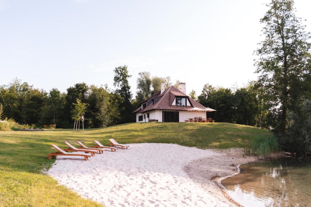 a group of lounge chairs on a beach next to a house at Le domaine de rountz in Rountzenheim