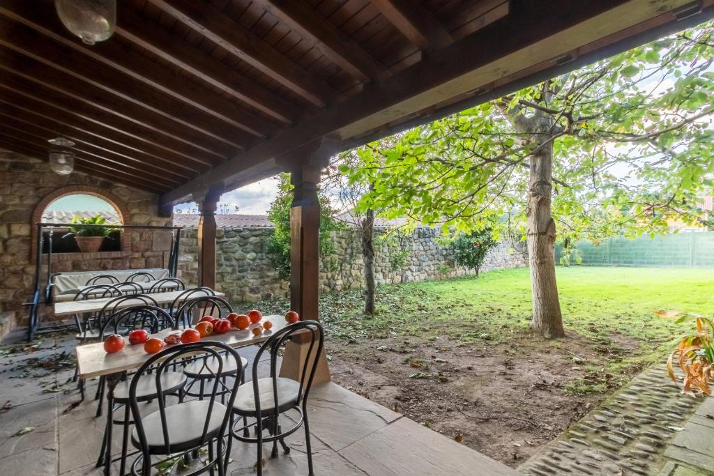 a patio with chairs and a table with fruit on it at Casa Velarde Apto 2 in Viérnoles