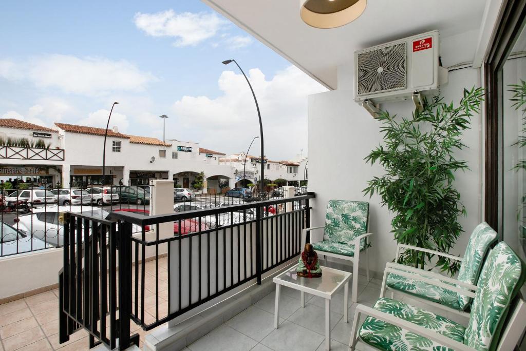 a balcony with chairs and a view of a marina at Loft Guanapay 1 in Arona