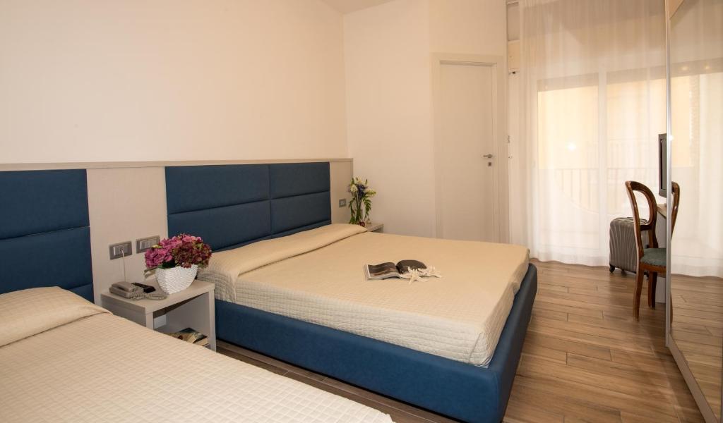 Postel nebo postele na pokoji v ubytování Hotel Nettuno