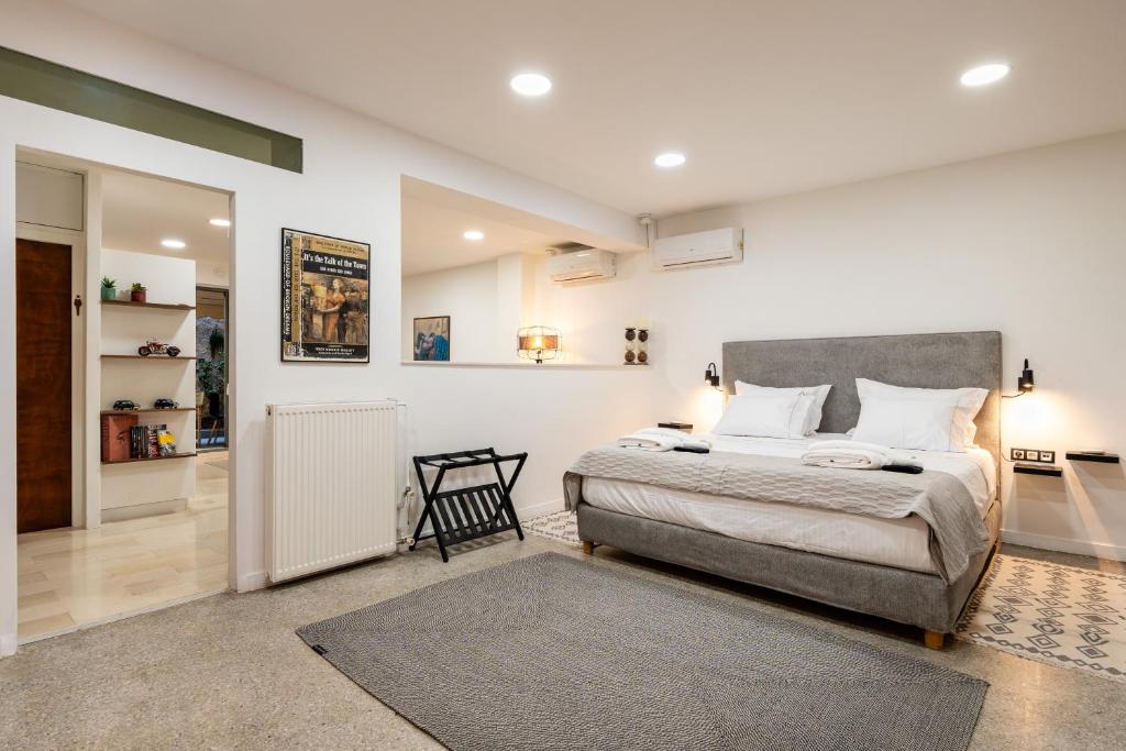 a bedroom with a bed and a chair in it at The Apex Boutique Studio in Athens