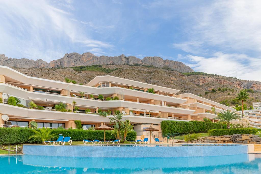 a resort with a swimming pool in front of a mountain at Altea La Nova in Bernia
