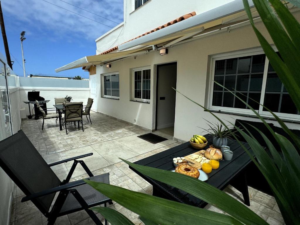 a patio with a table with food on it at Chalet Mar Y Montaña in Los Silos
