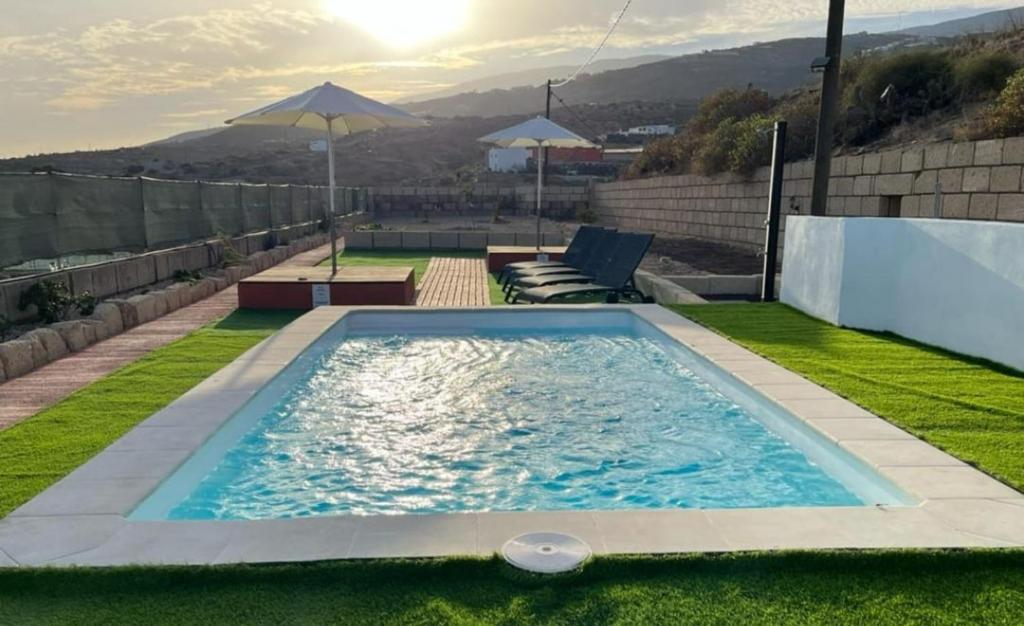 a swimming pool on the roof of a house at Finca Lucrecia in Fasnia