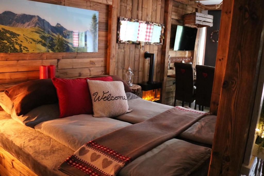 a couch in a room with a painting on the wall at Allgäu Fewo Hüttenflair Bergblick in Bad Hindelang