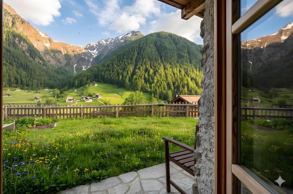 a view from a window of a mountain valley at Chalet Panorama Rabbi By Immobilux in Rabbi